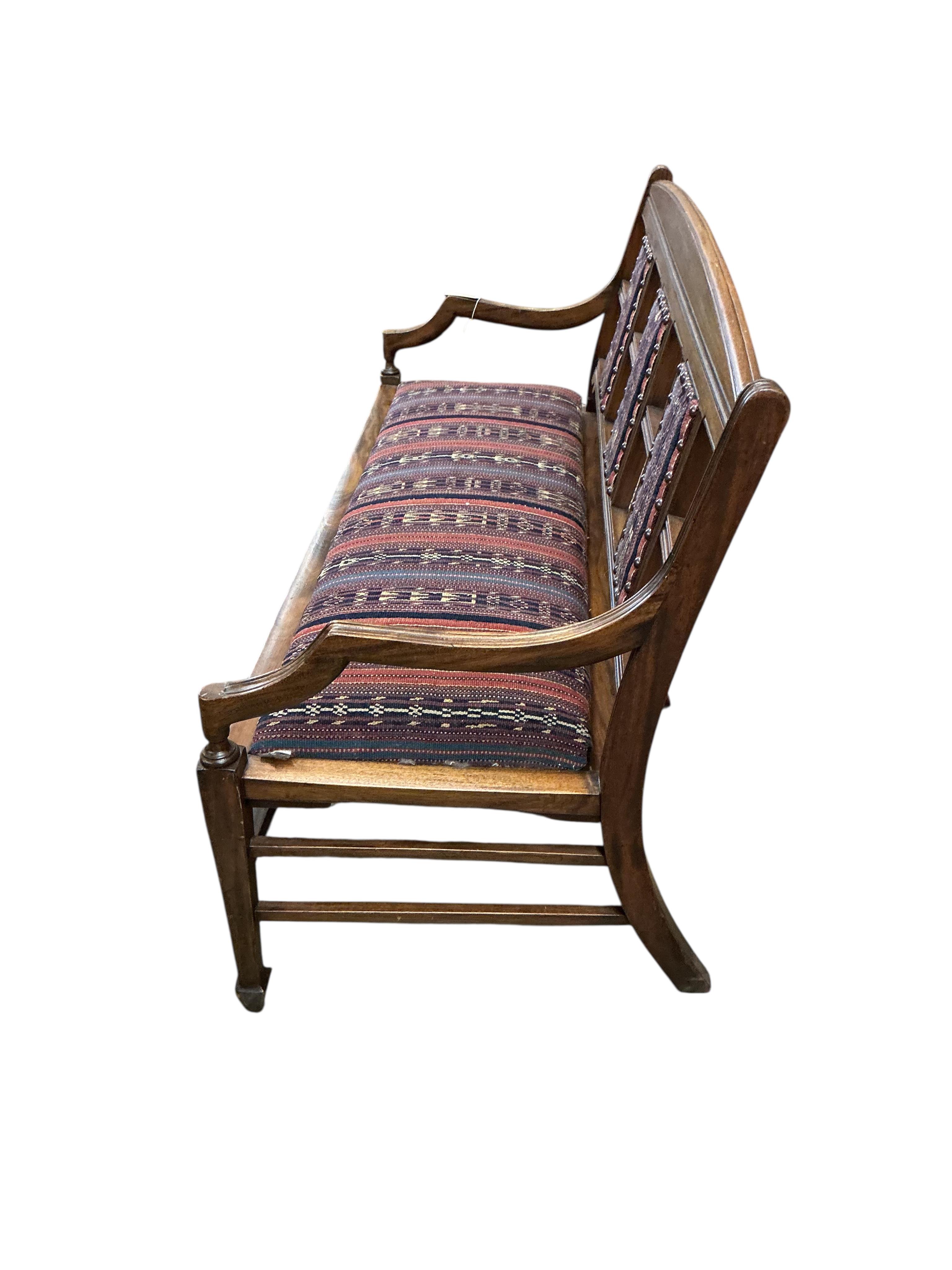 A late Victorian Aesthetic period walnut bench / settee, width 138cm, depth 50cm, height 80cm